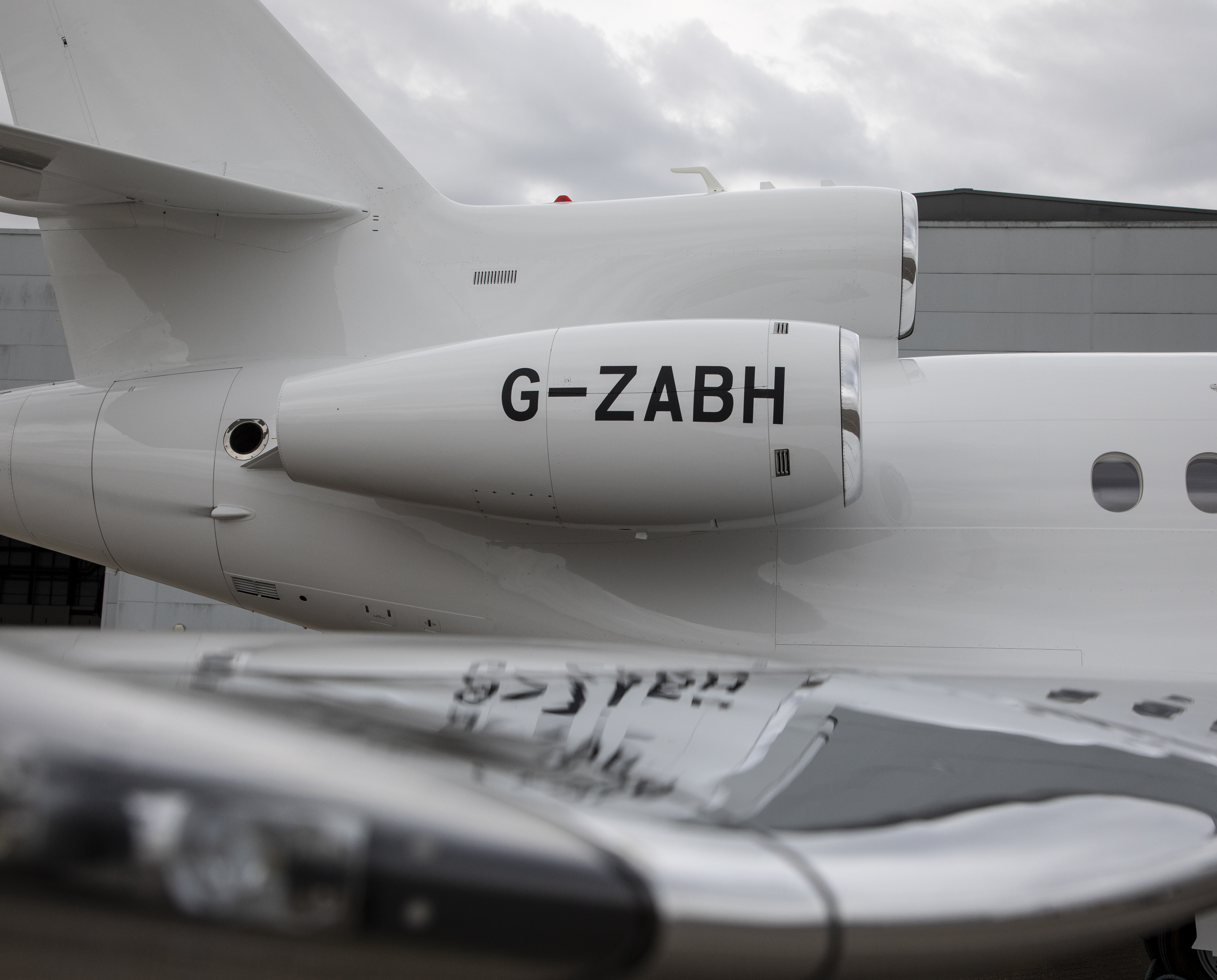 Image shows the side of the Envoy aircraft with G-ZABH painted on its side.
